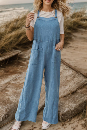 Light blue textured cotton overalls with square pockets and wide legs.