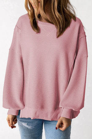 Dusty pink waffle knit pullover sweater with slit sleeves and crew neck.
