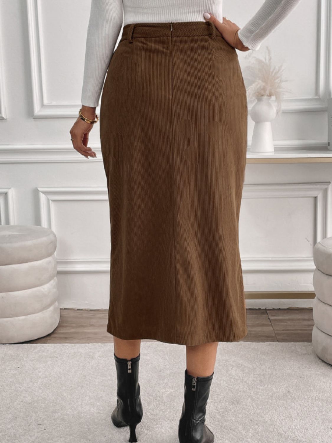 Brown corduroy midi skirt with slit-front detail and a zipper closure.