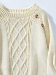 Cream cable knit raglan sweater with button shoulder detail.