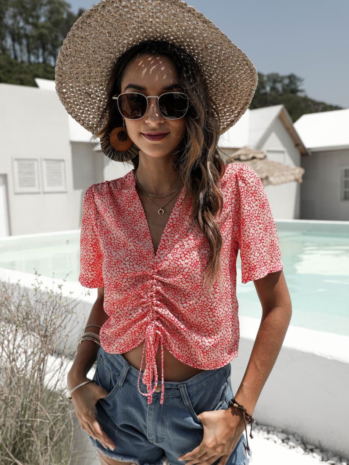 Red floral print ruched crop top with V-neck and short sleeves.