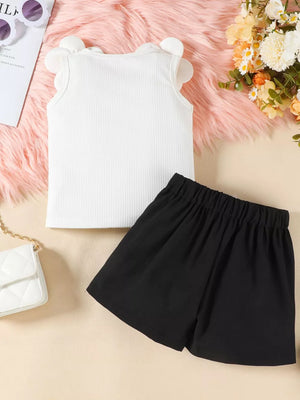 White ribbed tank top with floral applique trim and black bow skort set for baby girls.