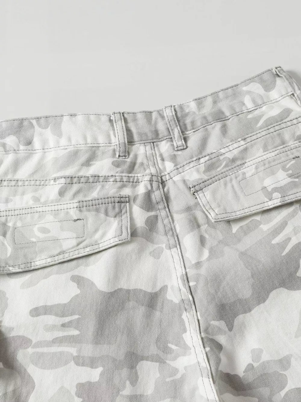 Men's grey camouflage utility cargo pants with multiple pockets.