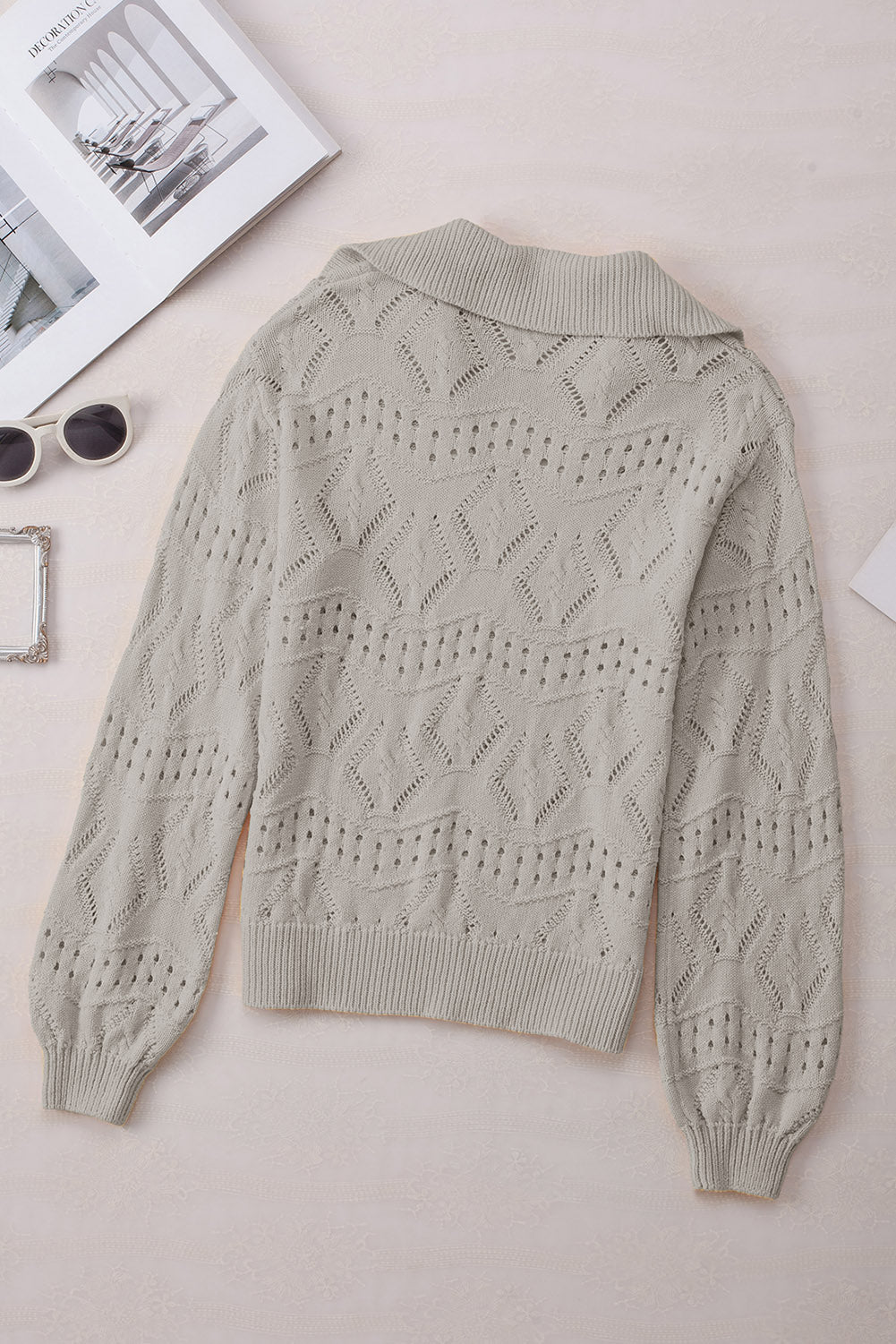 Gray openwork collar knit sweater with diamond pattern and ribbed cuffs.