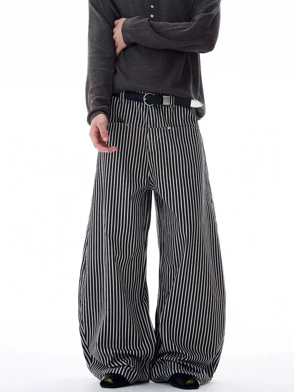 Men's black and white striped wide-leg sweatpants with a belt.