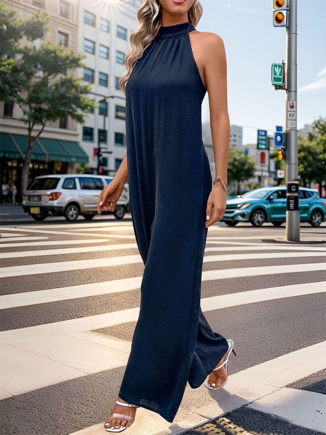 Dark blue halter neck wide leg jumpsuit with backless detail.