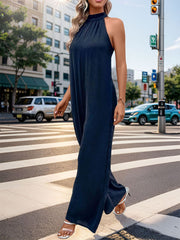 Dark blue halter neck wide leg jumpsuit with backless detail.