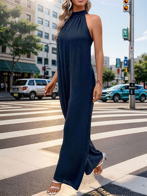 Dark blue halter neck wide leg jumpsuit with backless detail.