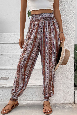 Bohemian smocked waistline trousers in multicolor stripe and floral print with cinched cuffs.