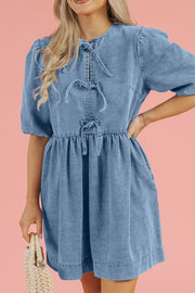 Prairie denim dress in medium with puff sleeves and tie details at the neckline and waist.