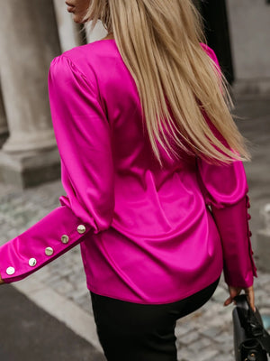 Hot Pink blouson sleeve blouse with button cuffs and V-neck.