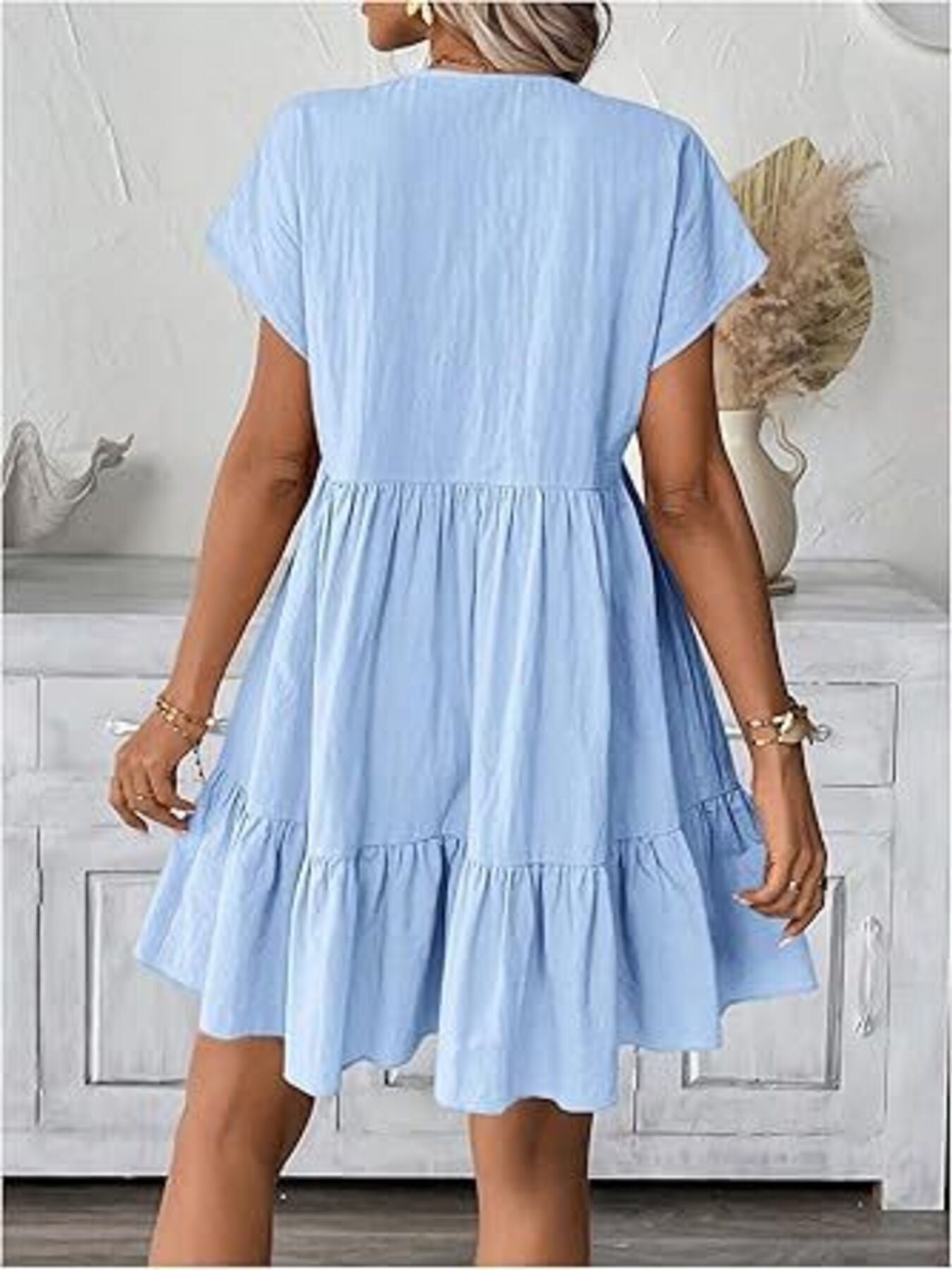 Sky blue ruffled mini dress with short sleeves and a tiered hem.