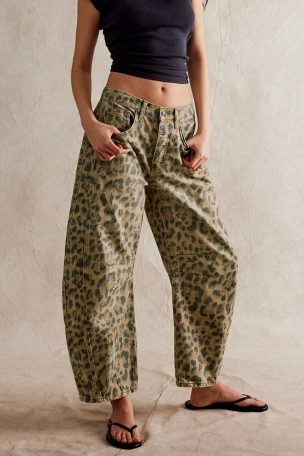 Leopard print barrel leg jeans with button fly and pockets.