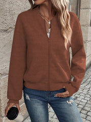 Caramel geometric quilted bomber jacket with zipper closure and ribbed cuffs.