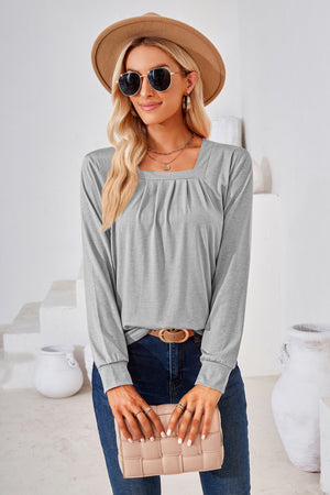 Light gray jersey top with gathered square neckline and long sleeves.