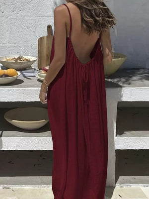 Burgundy backless maxi dress with spaghetti straps and drawstring detail.