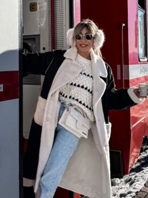 Textured stripe knit sweater with balloon sleeves and a black and white pattern.