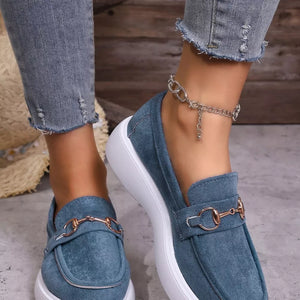 Blue loafers with gold horse-bit detail and white platform sole.