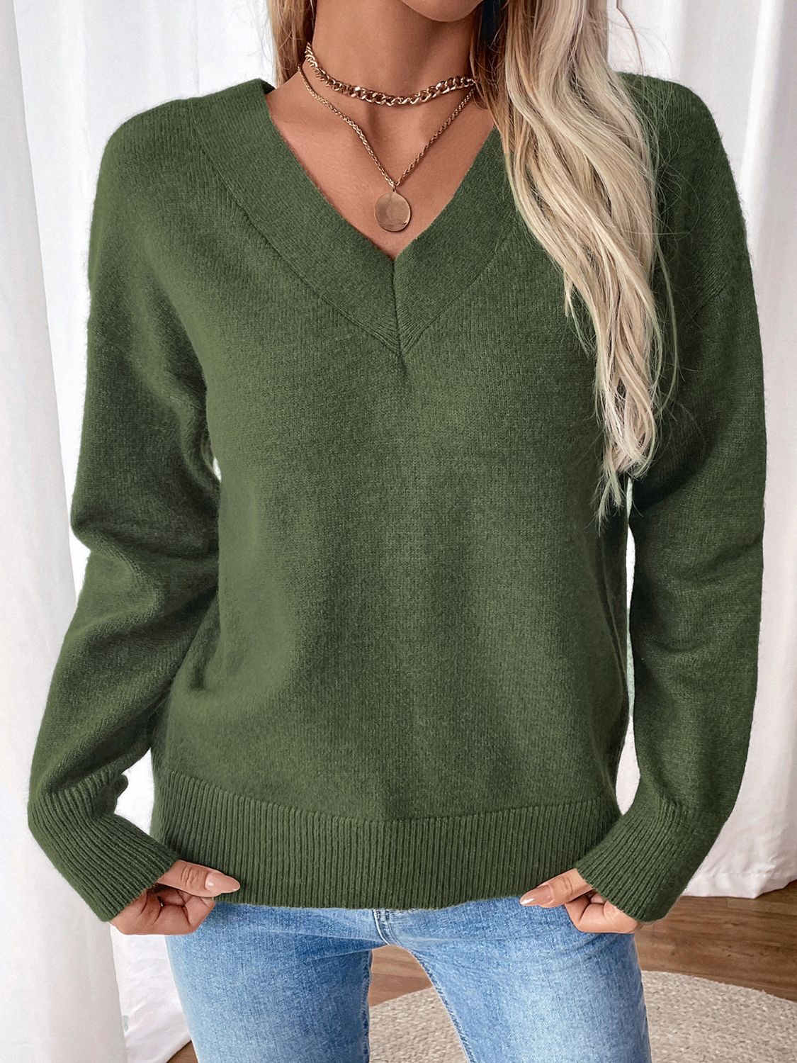 Army green acrylic v-neck sweater with a twisted back detail and ribbed cuffs and hem.
