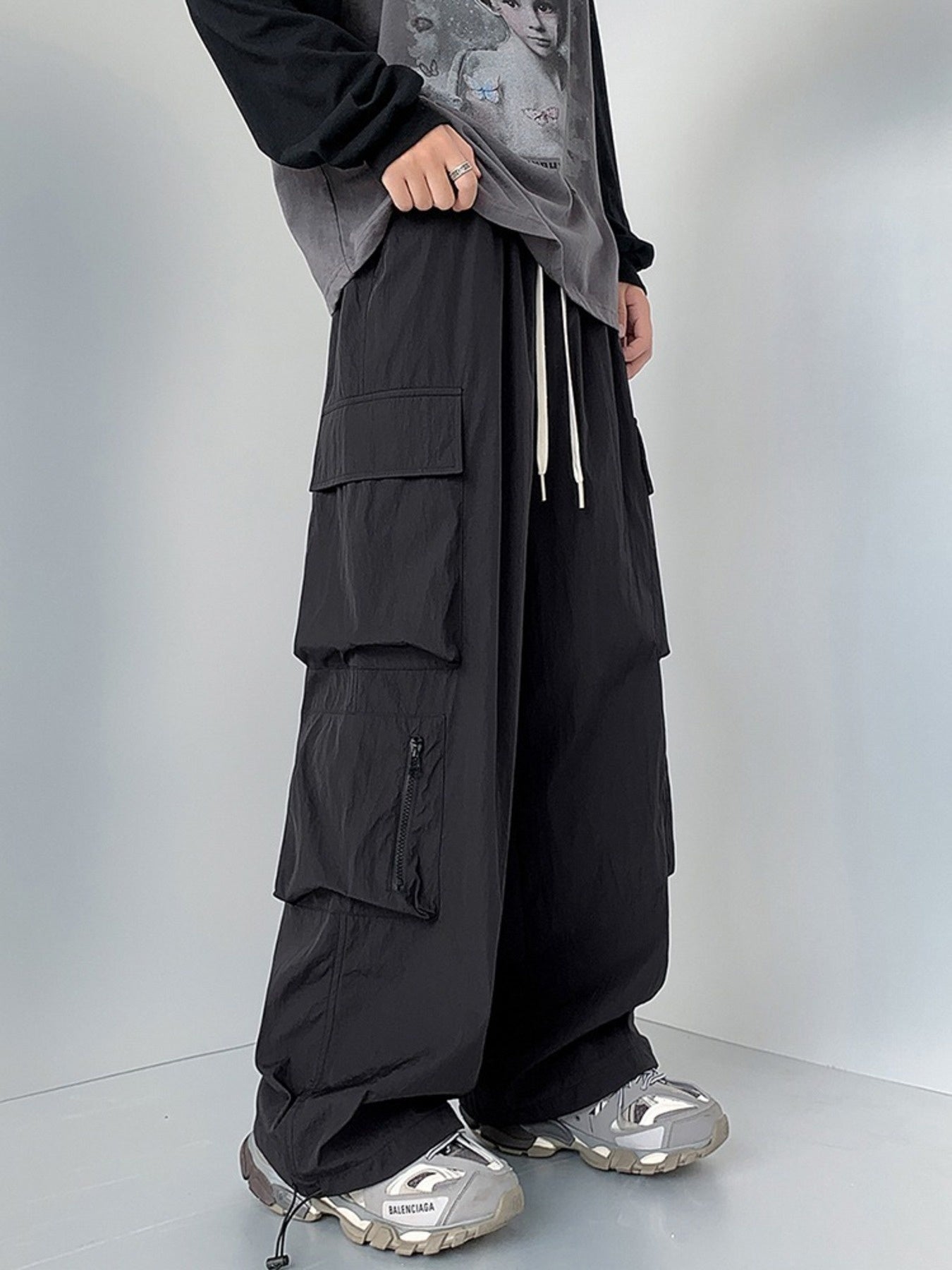 Men's black cargo sweatpants with drawstring and multiple pockets.