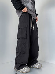 Men's black cargo sweatpants with drawstring and multiple pockets.