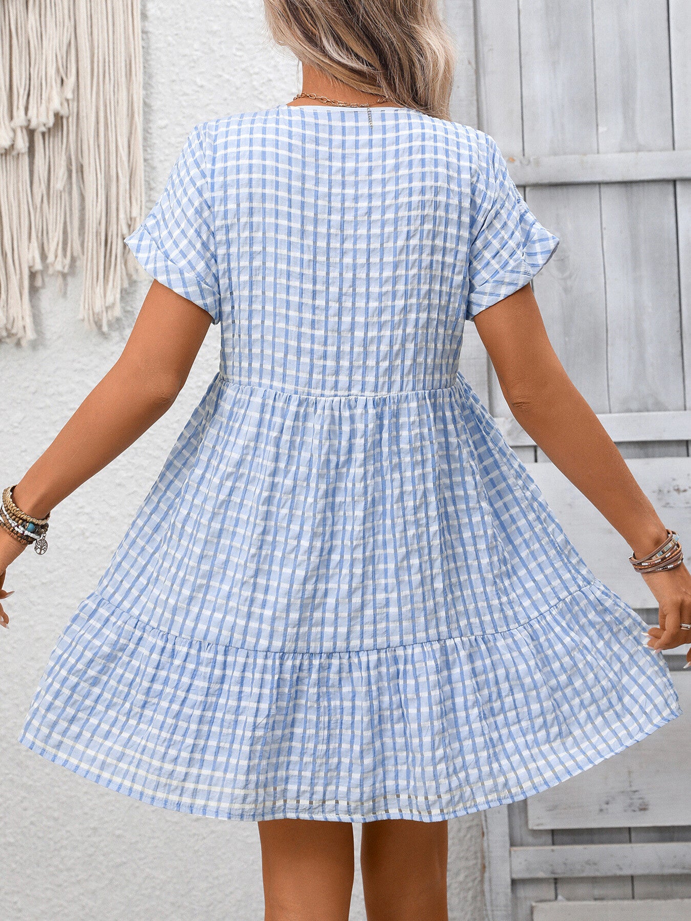 Light blue plaid V-neck mini dress with short sleeves and tiered skirt.