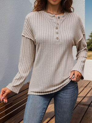 Textured tan henley shirt with button detail and flared sleeves.