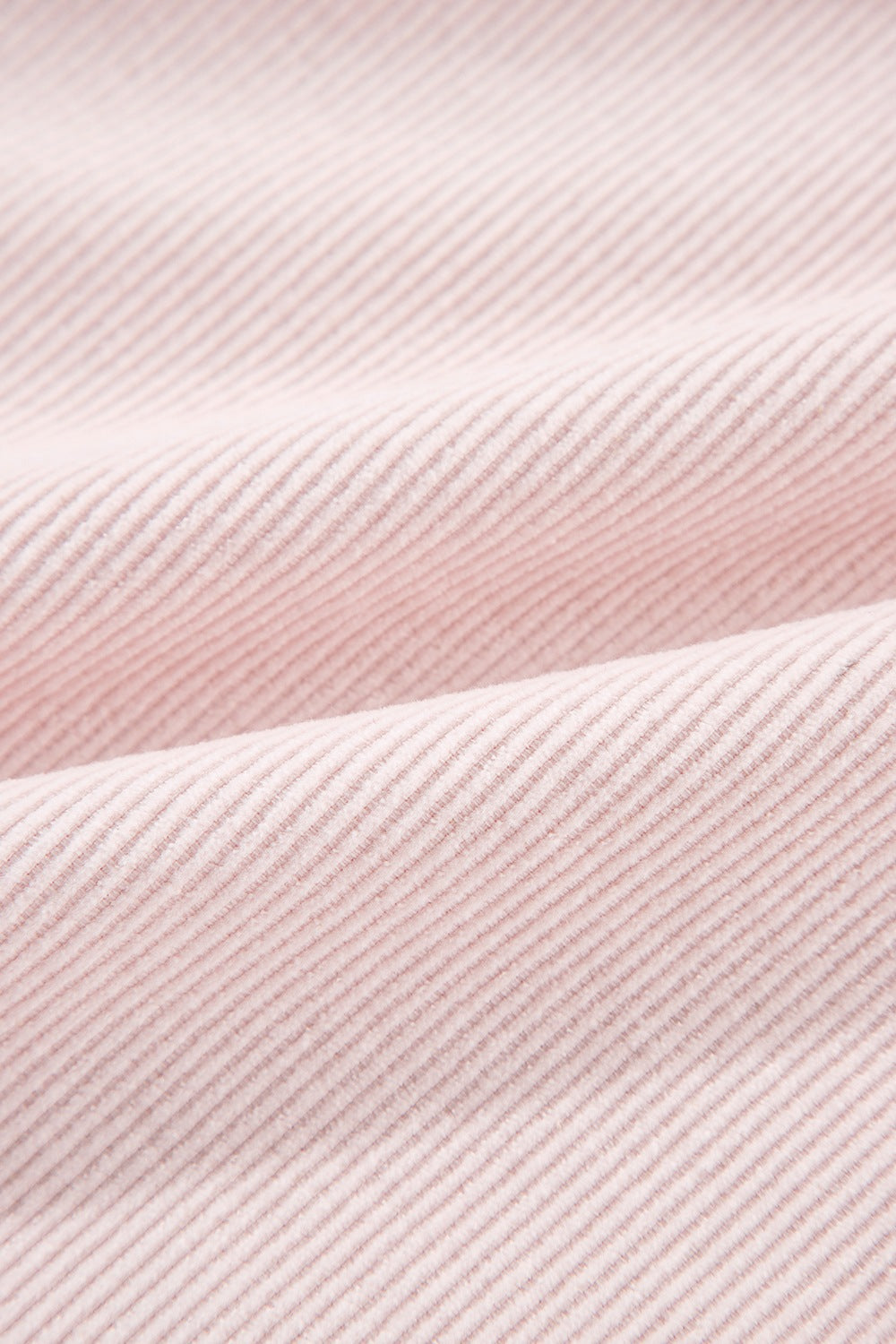 Blush pink corduroy shacket fabric with subtle texture and diagonal lines.