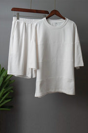 White relaxed fit sweatshirt with seam details and matching elastic waist shorts.