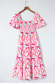 Midi dress in blush pink with abstract brushstroke print, smocked bodice, square neck, and balloon sleeves.