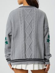 Gray cable knit cardigan with diamond pattern, stars on sleeve, and striped trim.