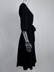 Black off-the-shoulder belted dress with 3/4 sleeves and a tie waist.