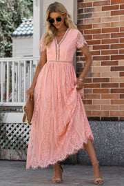 Peach lace midi dress with scalloped hem and short sleeves.