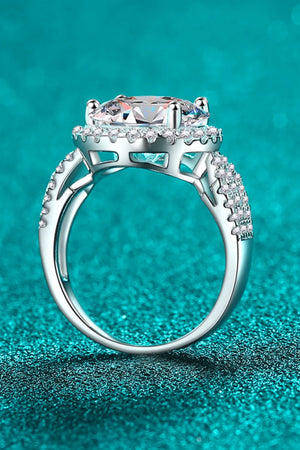 Silver halo moissanite ring with sculpted band and pavé details.