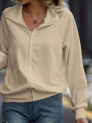 Tan ribbed zip-up track jacket with raglan sleeves and a stand-up collar.
