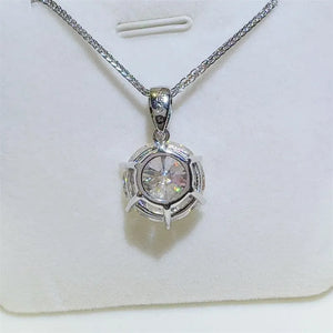 Silver moissanite solitaire pendant with a round-cut stone and prong setting.