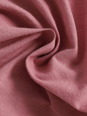 Pink baby set with ruffle trim and button front detail