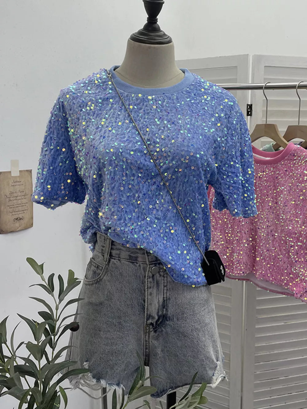 Blue crew neck t-shirt with iridescent sequin embellishments, short sleeves.