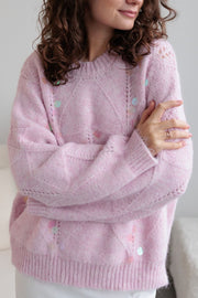 Blush pink diamond knit sweater with scattered pastel sequins and open knit details.