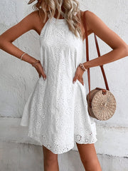White eyelet halter trapeze dress with floral embroidery and scalloped hem