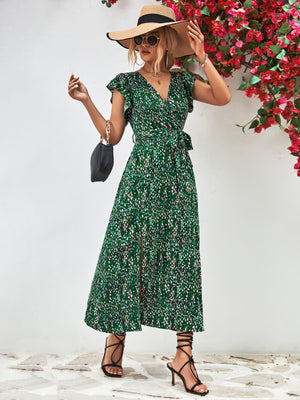 Green floral wrap midi dress with flutter sleeves and a belted waist.