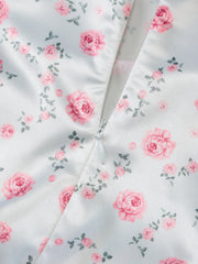 Print midi dress with spaghetti straps in white satin with a pink floral print and side zipper detail.