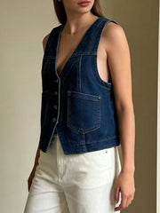 Dark blue denim button-down vest with brass buttons and chest pockets