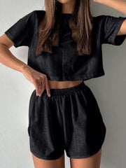 Black perforated crop top and shorts set with elastic waistband.