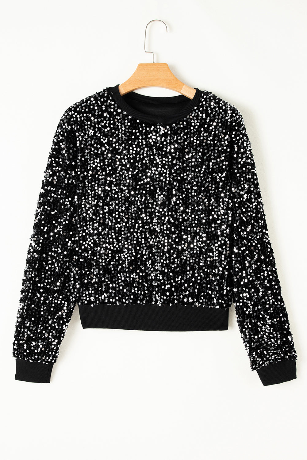 Black sequin embellished sweatshirt with ribbed cuffs and hem.