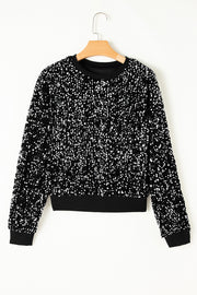 Black sequin embellished sweatshirt with ribbed cuffs and hem.