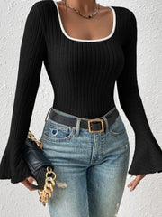 Black ribbed flare sleeve top with contrast white neckline trim.