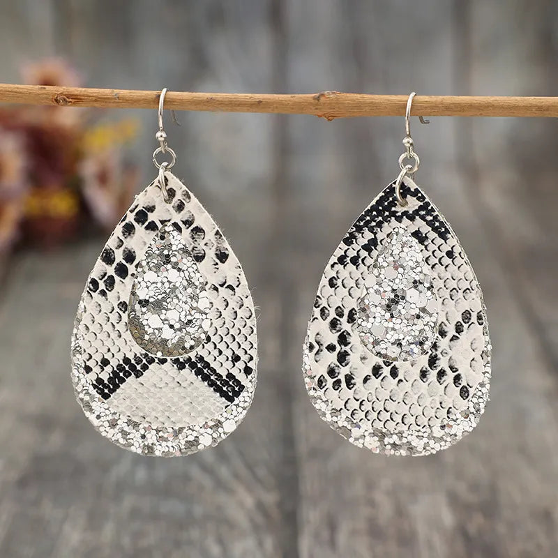 Python print and glitter drop earrings in silver with a teardrop shape.