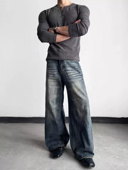 Men's blue distressed wide-leg denim jeans with a relaxed fit.