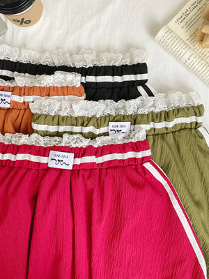 Mini skirts in red, orange, army green, and black with lace trim and white side stripes.